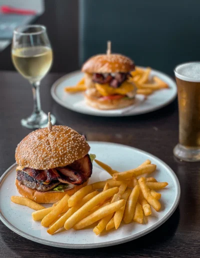 Dick Burger house made patty, american cheese, bacon, lettuce, tomato, mustard aioli, pickles, steak chips